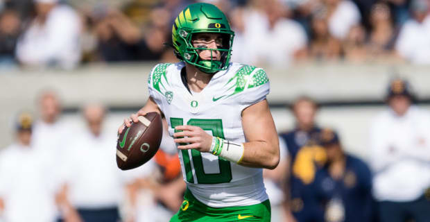 Oregon Ducks quarterback Bo Nix attempts a pass during a college football game.